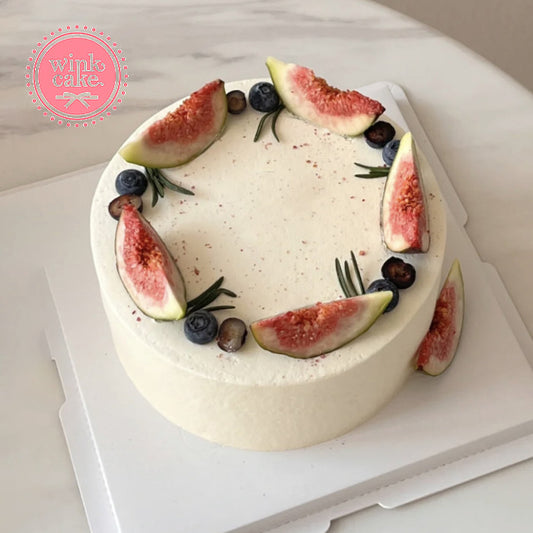 Birthday cake, fruit cream cake decorated with dried figs and blueberries.