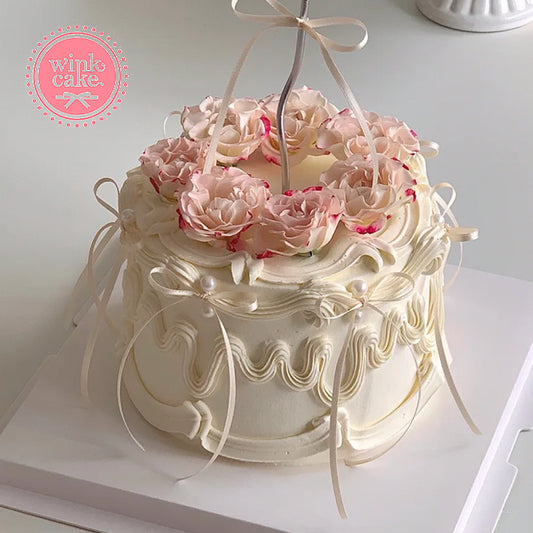 Pink wreath birthday cake, perfect for a girl's birthday with winkcake.
